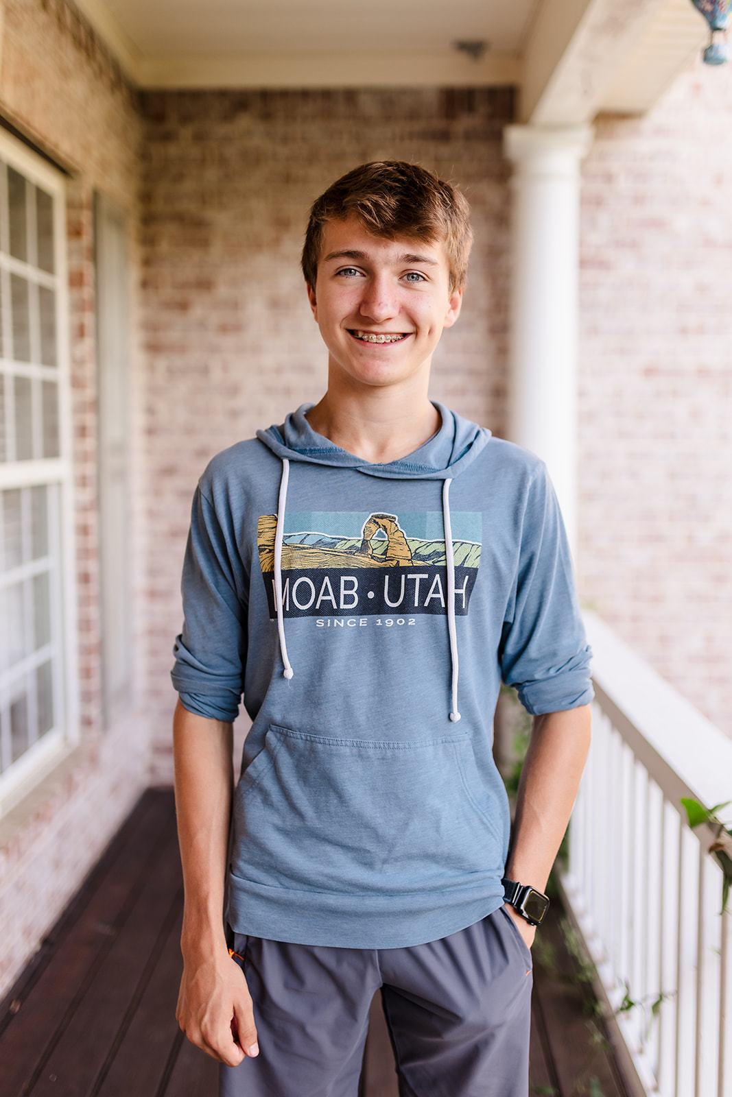 Portrait of Titus Johnson smiling on a porch